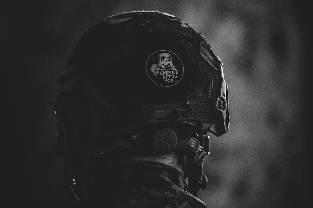 grayscale photo of man wearing helmet