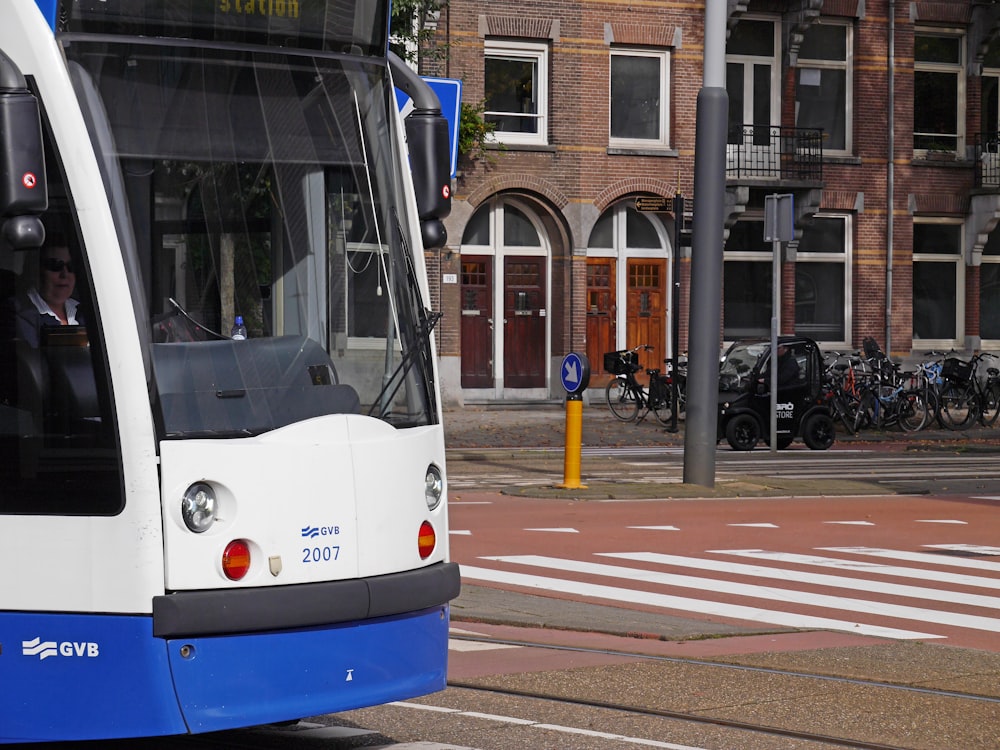 white and blue tram on road during daytime