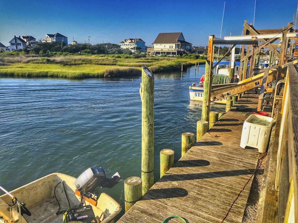 brown wooden dock on lake during daytime