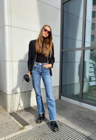 Lifestyle scene of a woman enjoying coffee while wearing a tailored blazer.