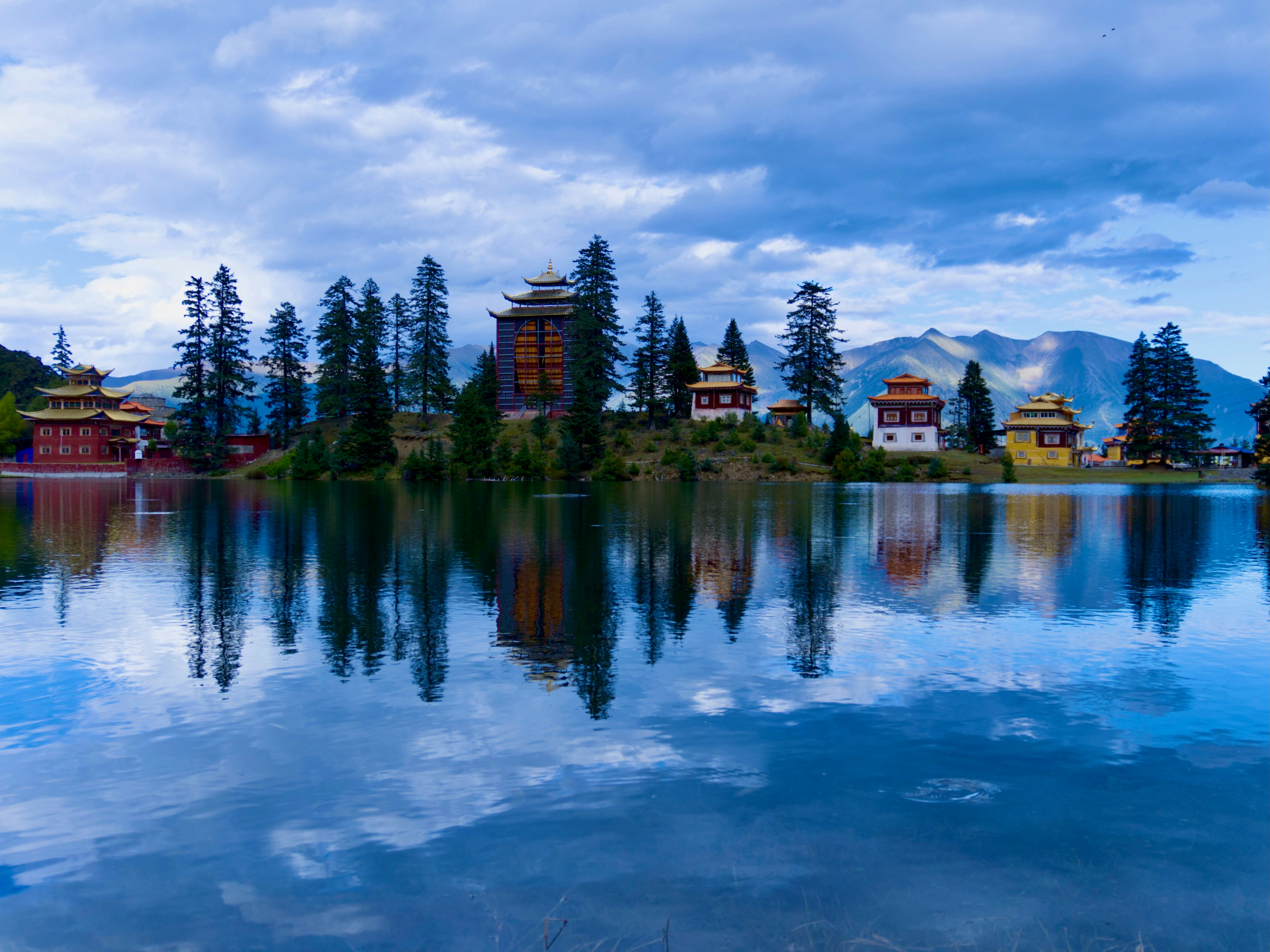Potala Palace Lhasa Tibet reflected in a calm lake at dawn with soft pink sky