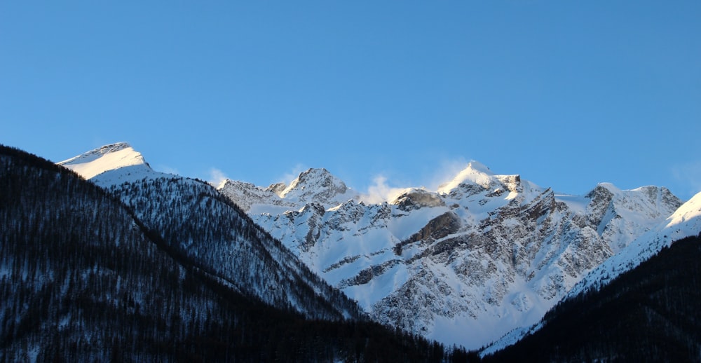 snow covered mountain under blue sky during daytime