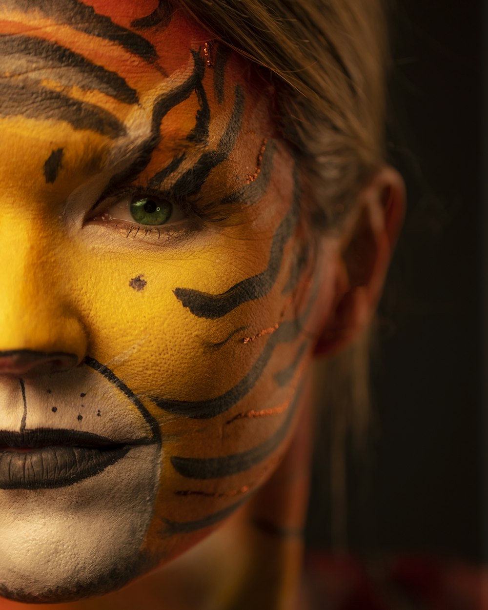 woman with yellow and black face paint