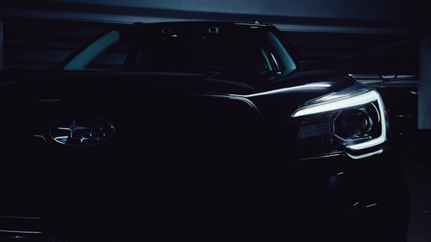 Dark-themed image showing a professional automotive consultant explaining car features to a client.