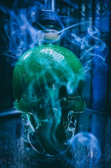 A mysterious bottle of dark humic and fulvic acid glowing faintly under dim light, surrounded by roots and ancient scrolls.