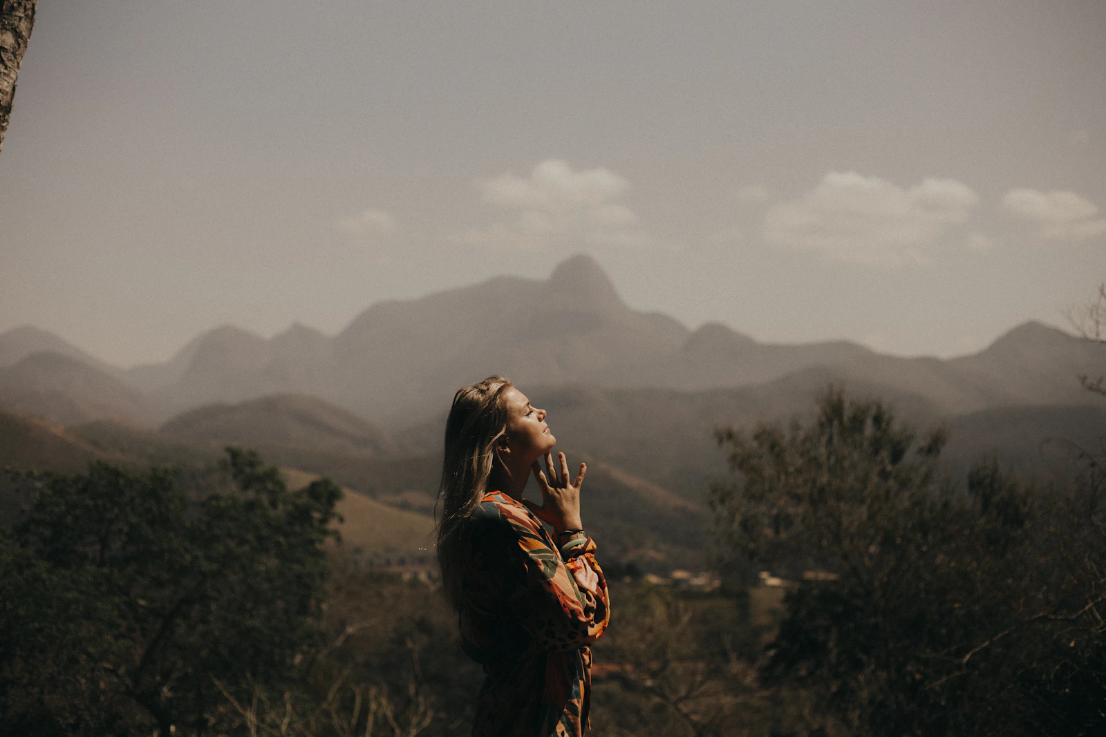 Person standing outdoors and reconnecting with their own needs and sense of self