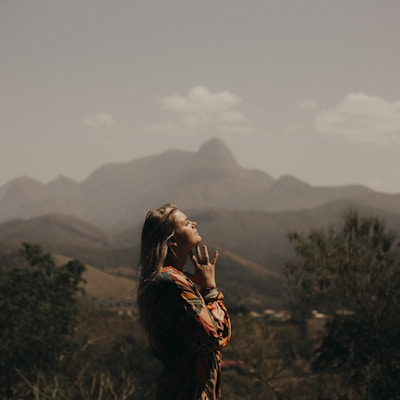 woman in black jacket standing on green grass field during daytime