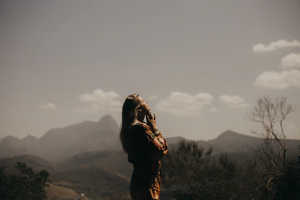 Woman calm, breathing deeply in green field