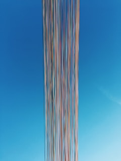 white and blue striped tower under blue sky