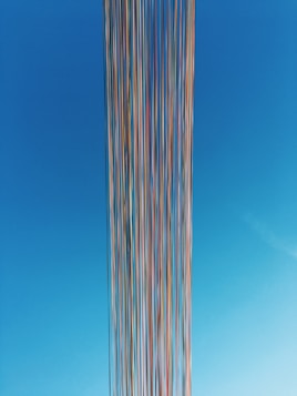 white and blue striped tower under blue sky