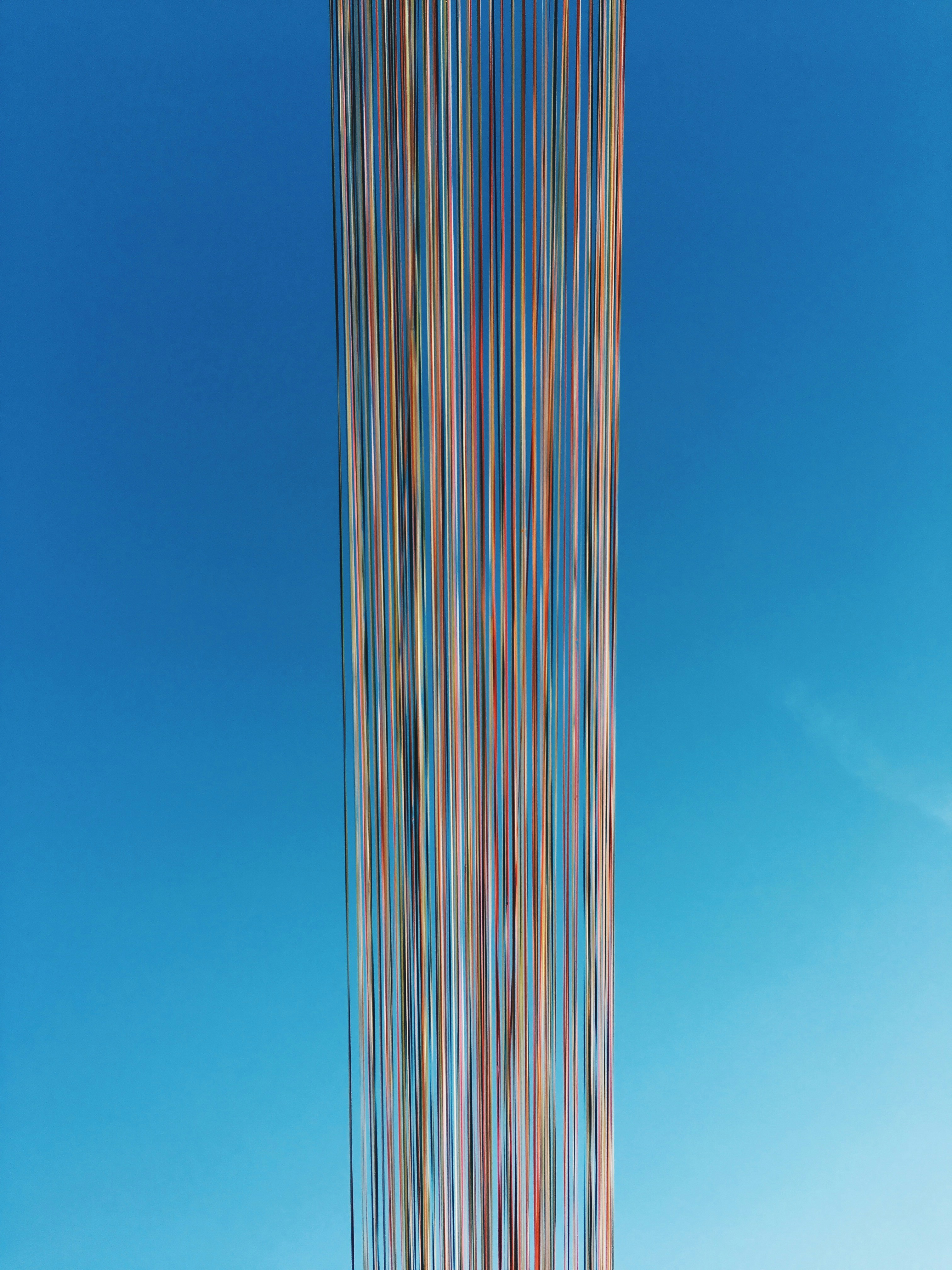 white and blue striped tower under blue sky