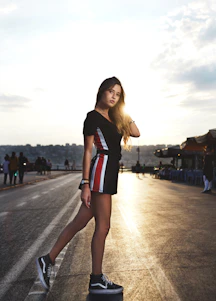 B1 standing confidently outdoors with a warm Florida sunset behind him.