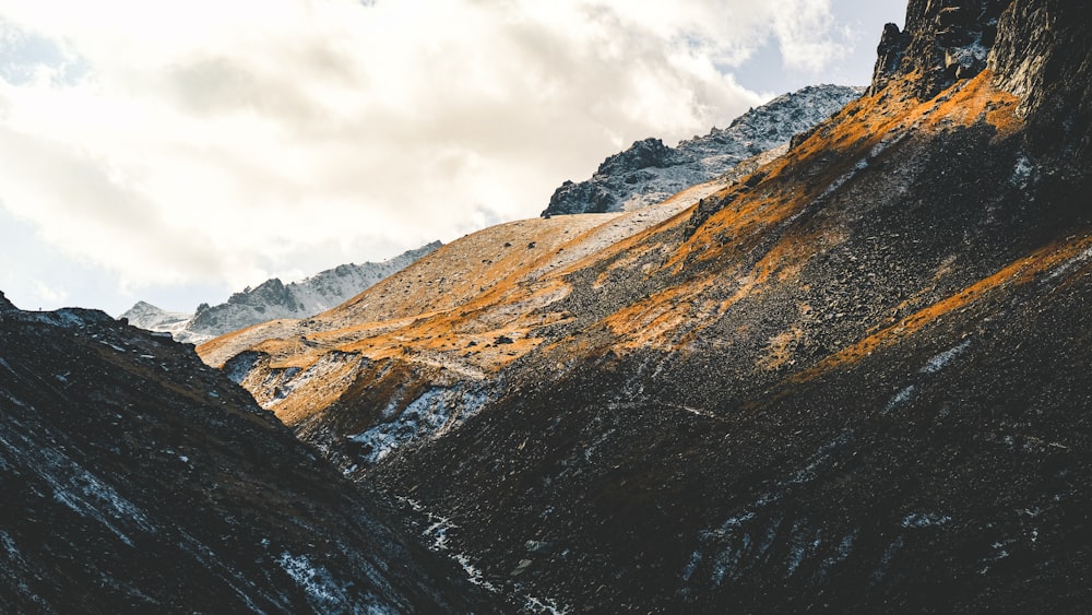 brown and gray mountains under white cloudy sky during daytime