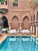 white ceramic chairs near swimming pool