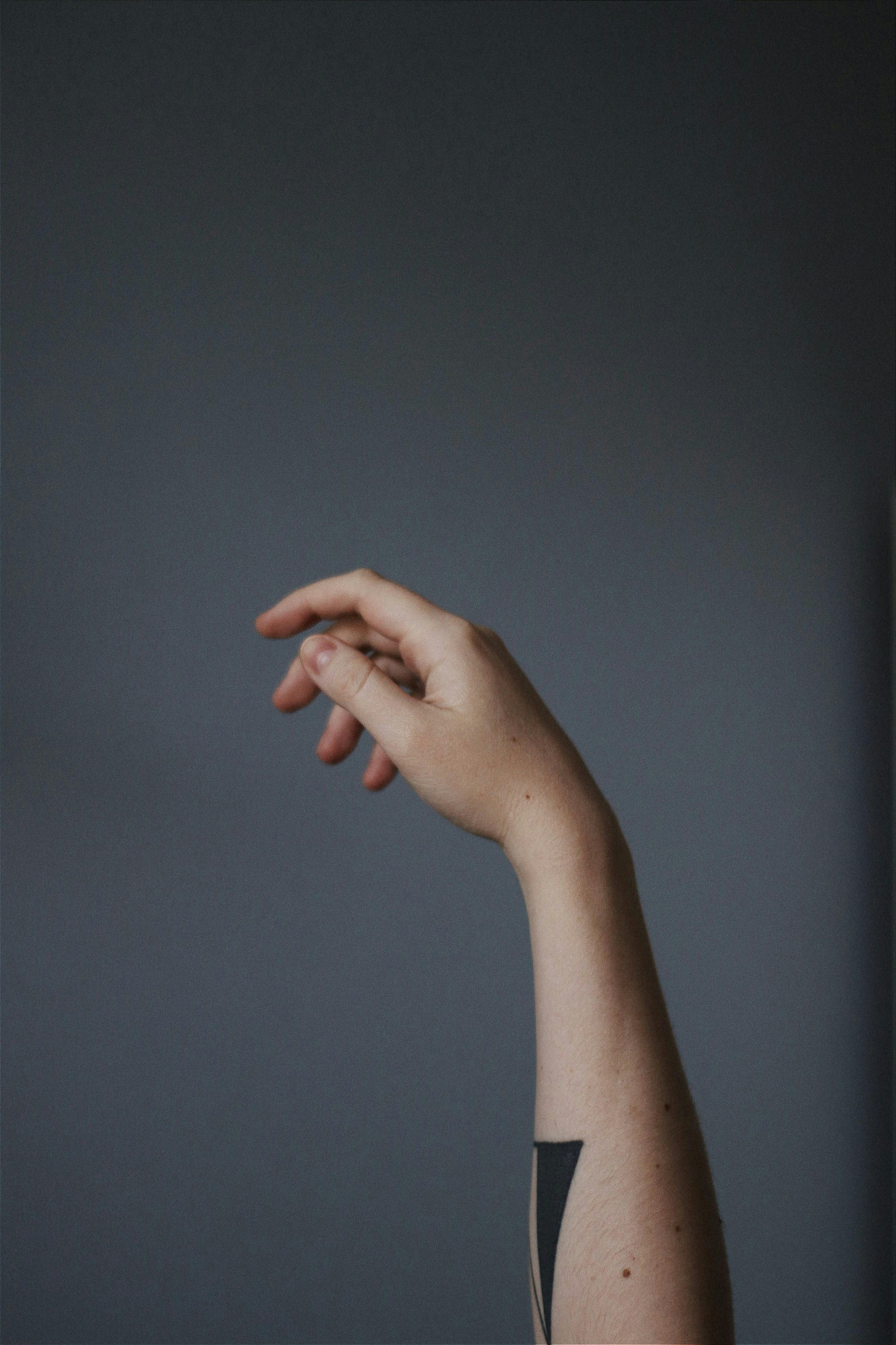 persons left hand doing okay sign