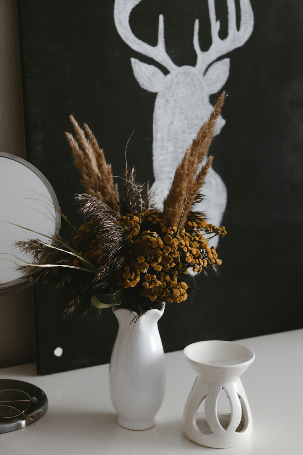 brown and white plant on white ceramic vase