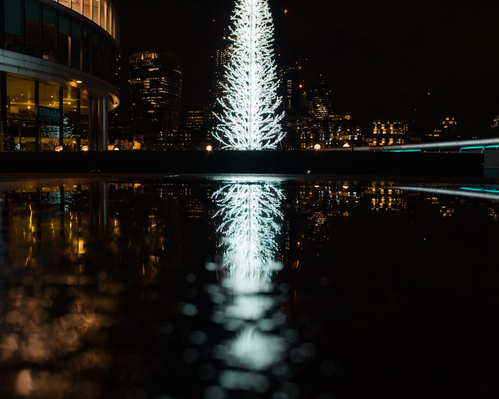 lighted building near body of water during night time