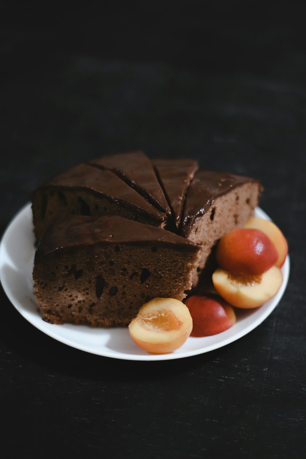 sliced chocolate cake on white ceramic plate