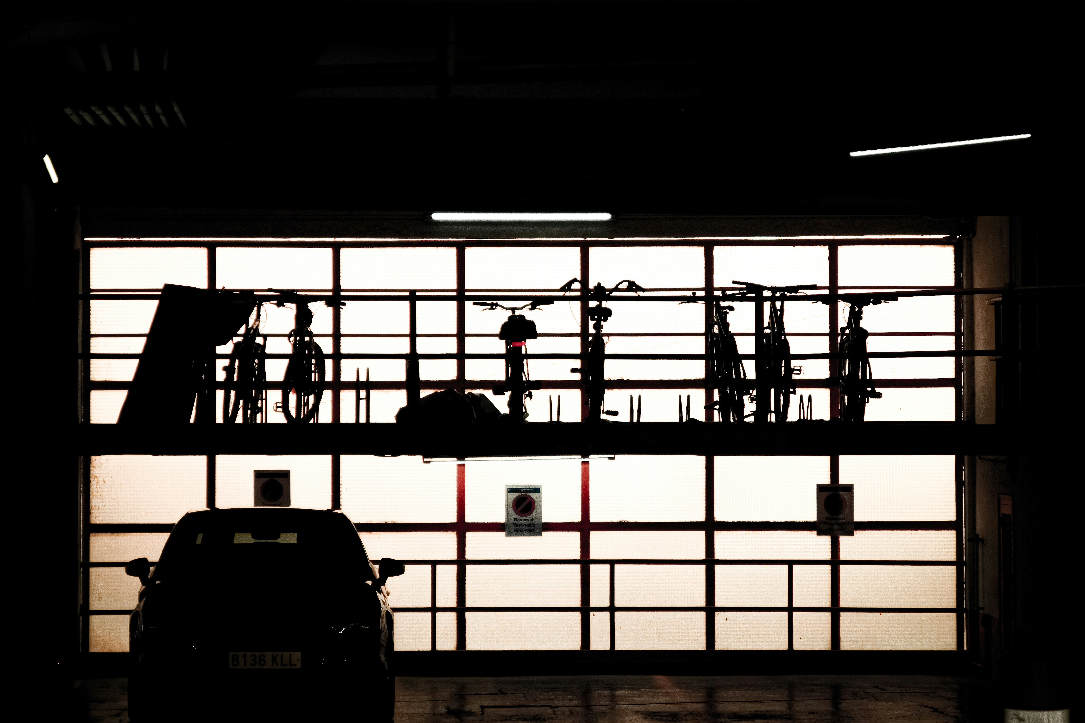 black car parked in front of white and red building
