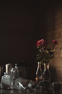 A moody kitchen scene with jars of bubbling ferments on a wooden shelf, lit by soft candlelight