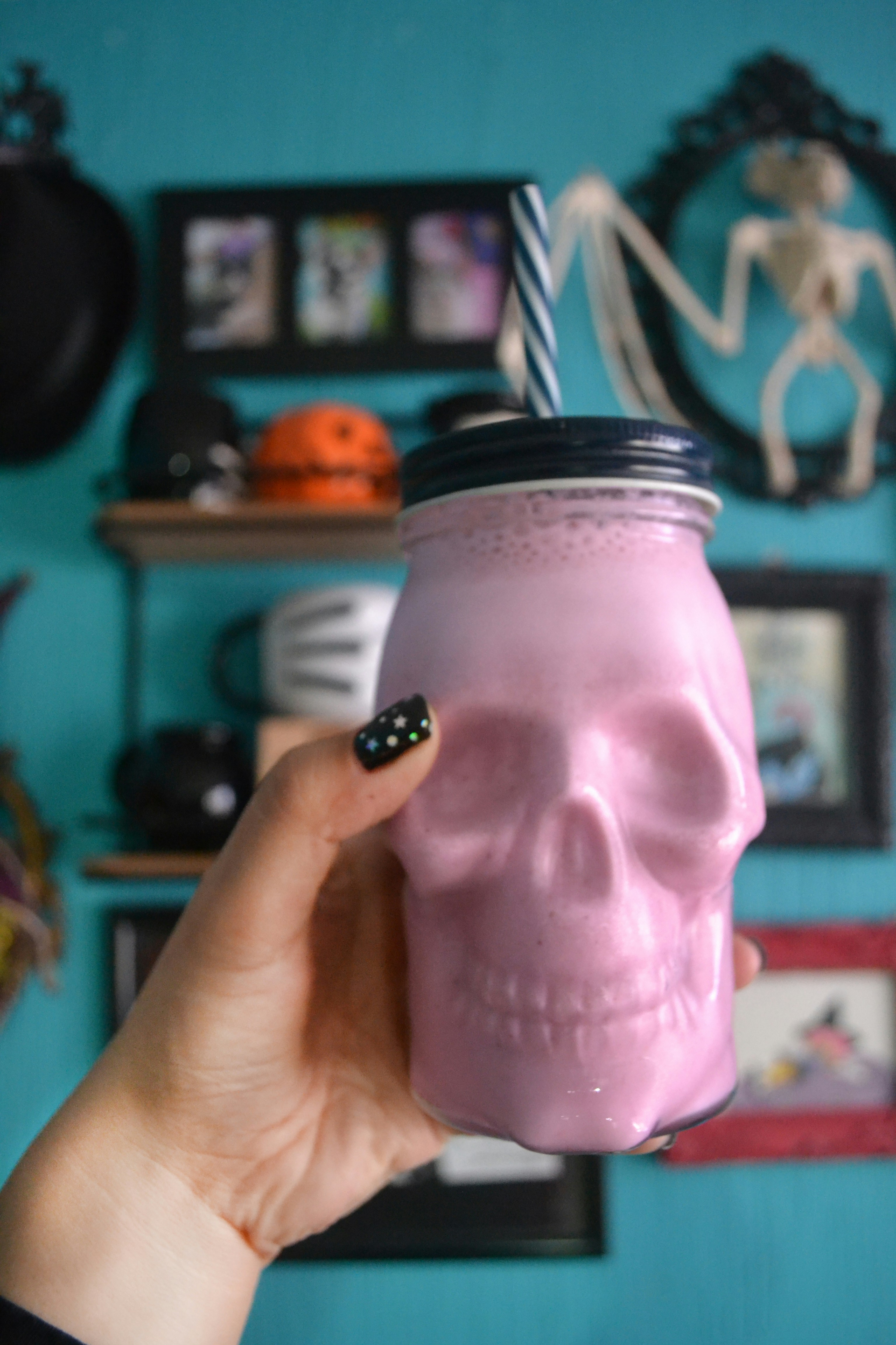 person holding pink glass jar