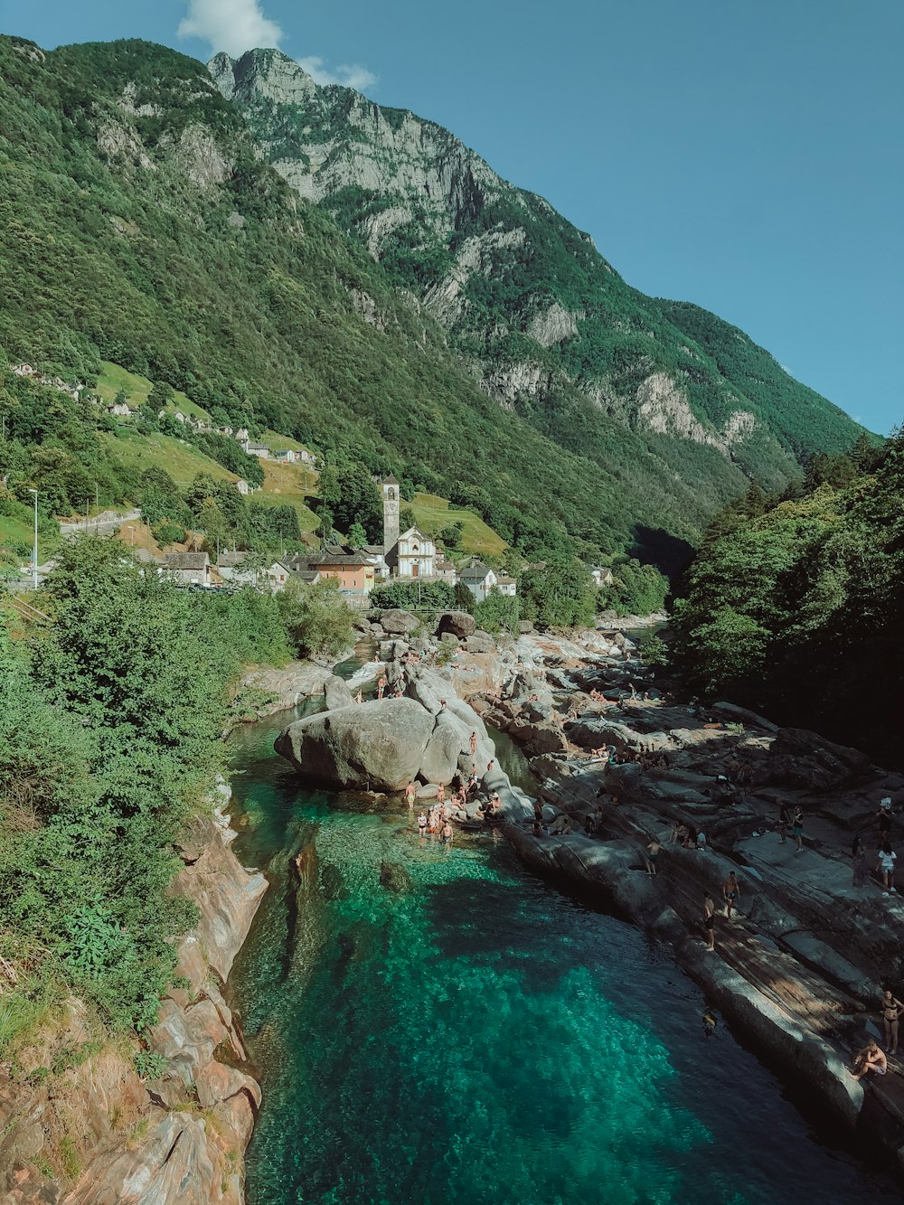 green and brown mountains beside river during daytime