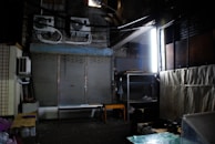 skilled technicians using industrial fans and dehumidifiers in a water-damaged room with visible but controlled water stains