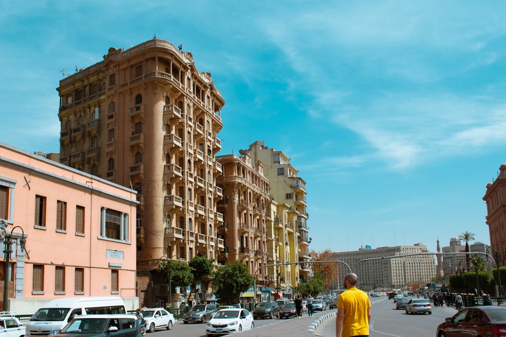 cars parked in front of brown concrete building during daytime