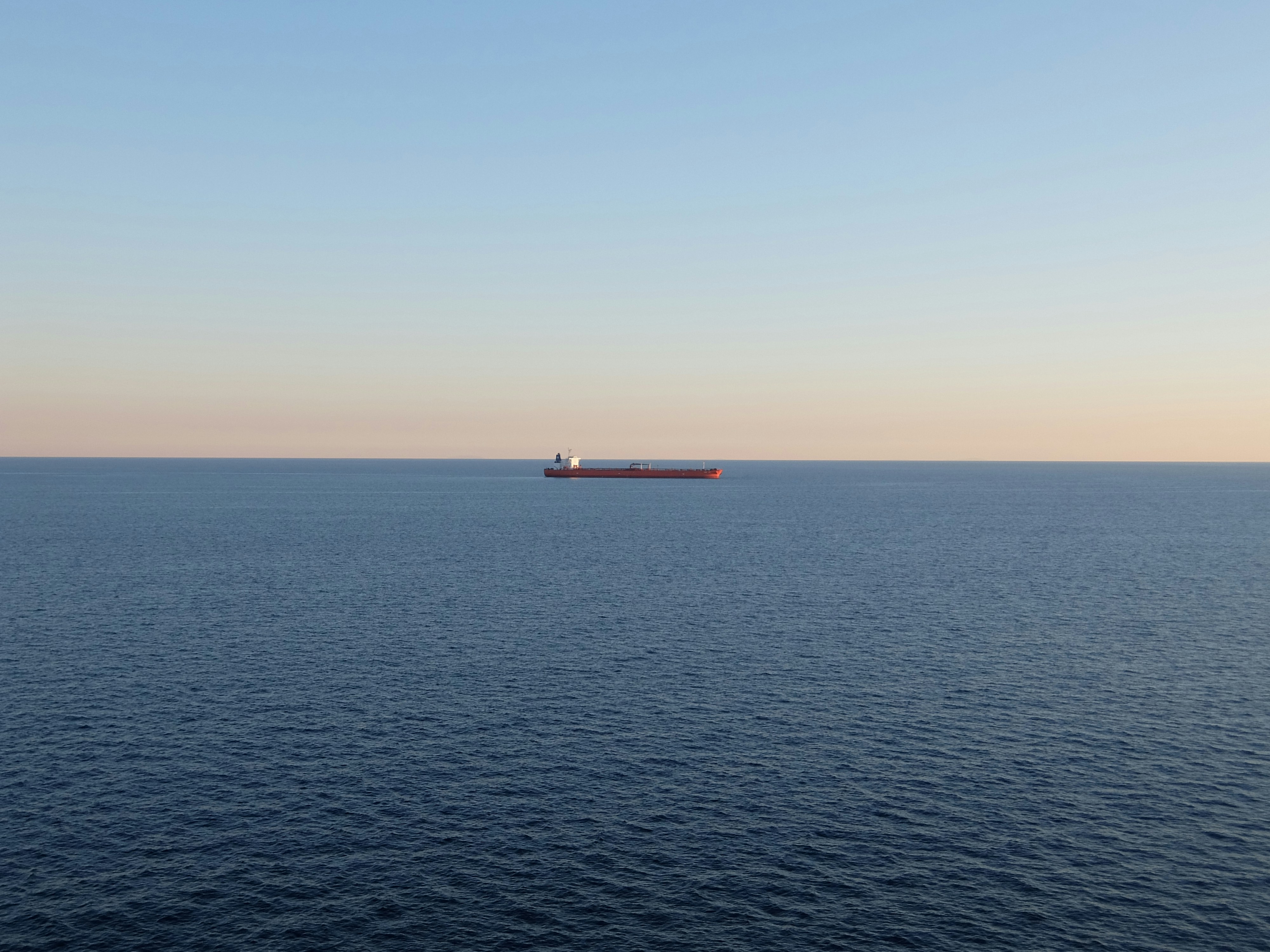 red and white ship on sea during daytime