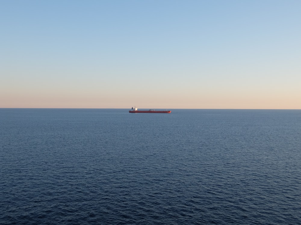 red and white ship on sea during daytime