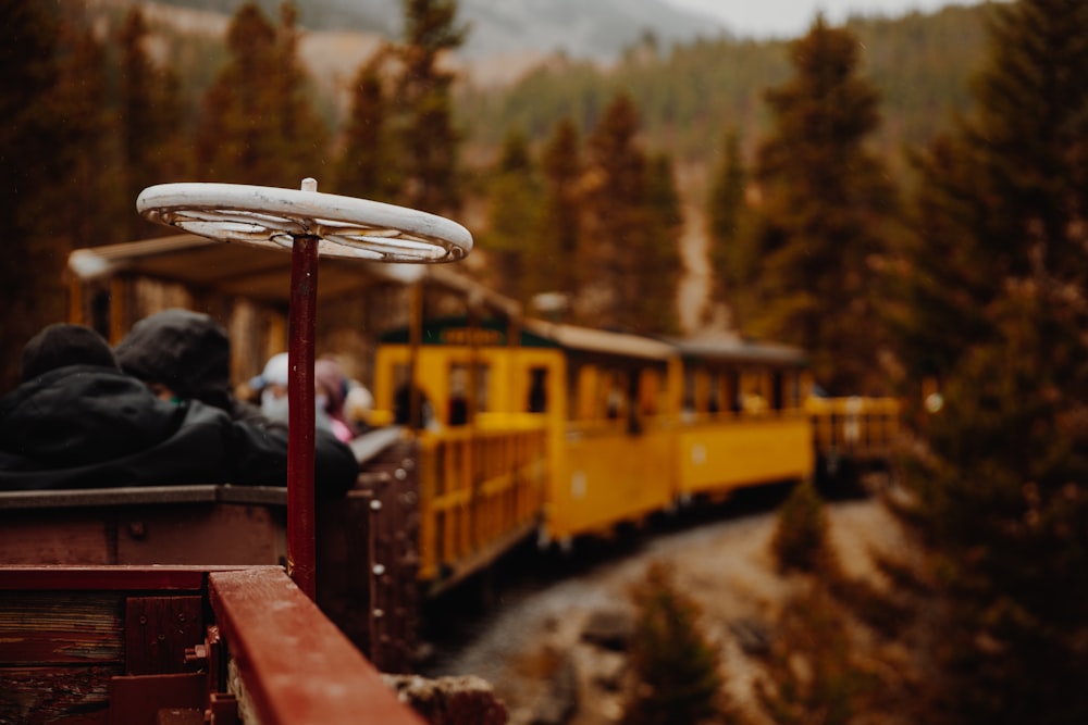 yellow and red train on rail tracks