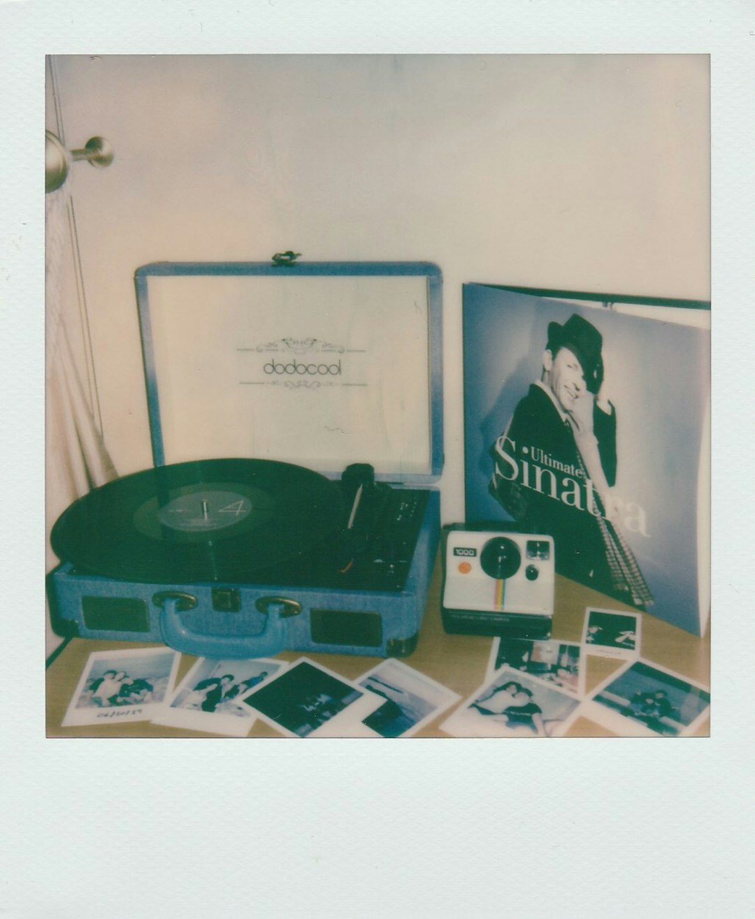 Sinatra record album and record player with Polaroid photos