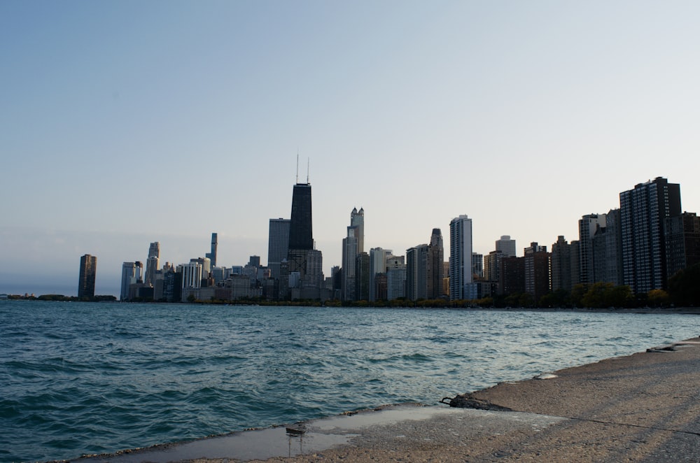 city skyline across body of water during daytime