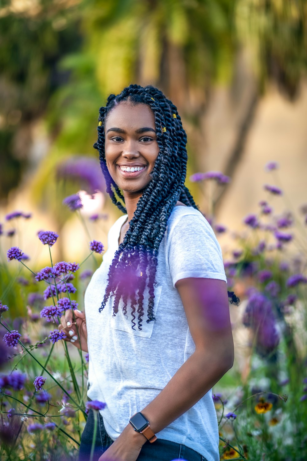 woman in white t-shirt standing on purple flower field during daytime