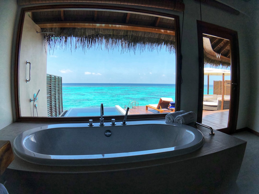 brown and white hot tub, Bathtub in an Overwater Villa at the W Hotel luxury resort in the Maldives.