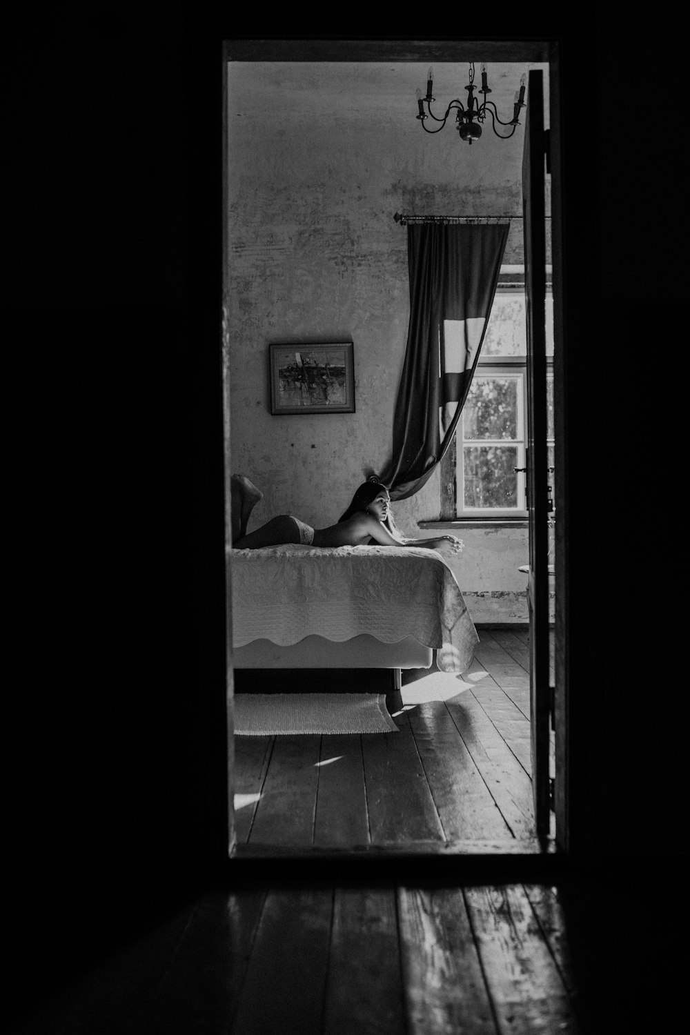 grayscale photo of bed near window