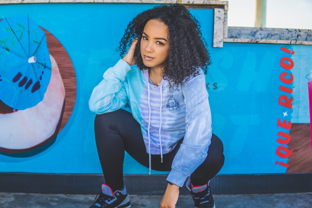 woman in white zip up jacket and black pants