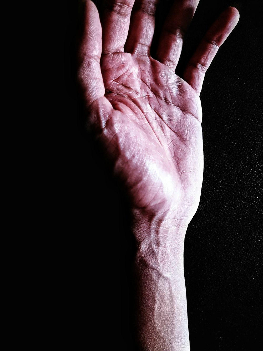 persons hand on black textile