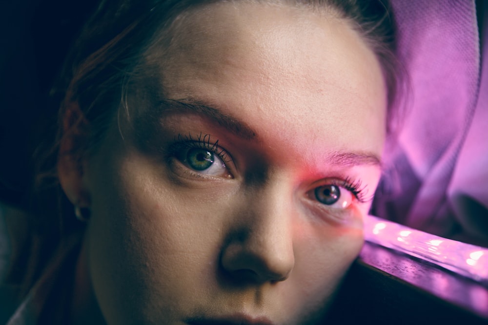 woman with pink lipstick taking self portrait