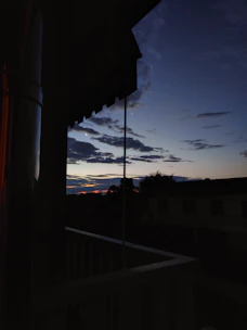 Balcony view overlooking Bangalore skyline at sunset.