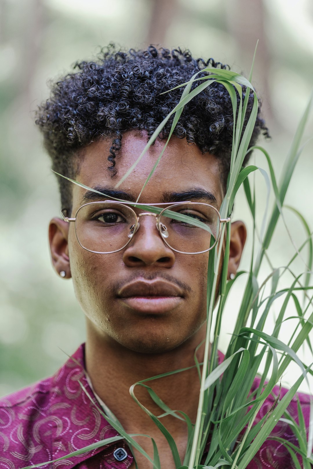 man in purple shirt wearing eyeglasses