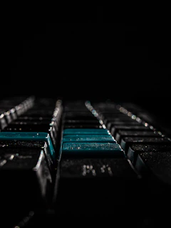 An artistic shot of a keyboard with typed jokes on screen, set against a dark, aesthetic background.