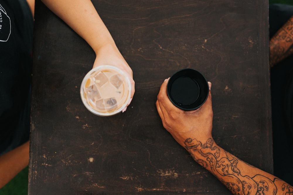 person holding white plastic cup