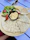 A colorful meze platter featuring hummus, olives, grilled vegetables, and warm bread on a rustic wooden table.