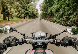 man riding motorcycle on road during daytime