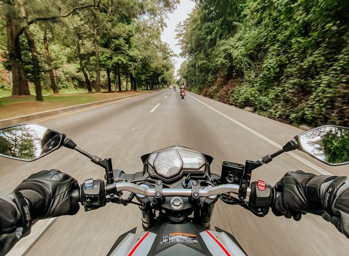 man riding motorcycle on road during daytime