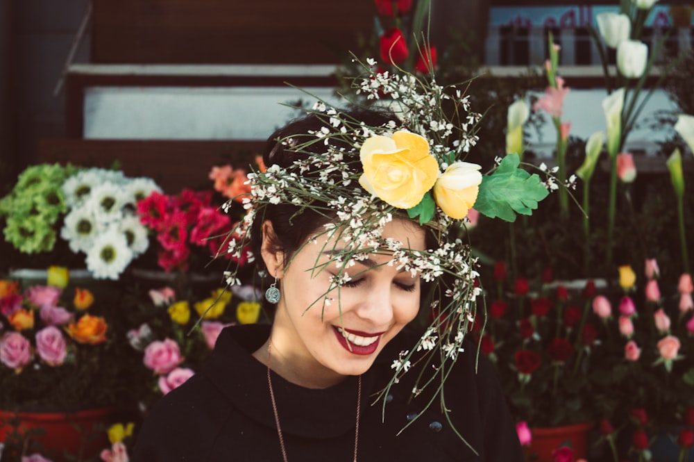 woman in black crew neck shirt with yellow rose on her head