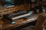 black and white computer keyboard on brown wooden table