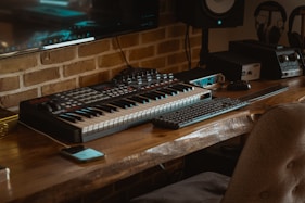 black and white computer keyboard on brown wooden table