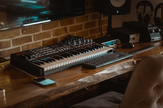 black and white computer keyboard on brown wooden table